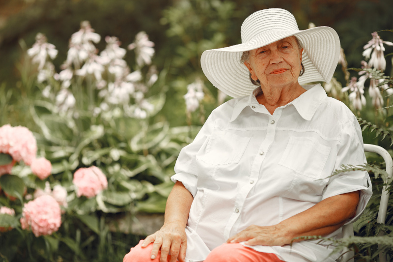 aged-woman-sitting-park-grandma-white-hat.jpg